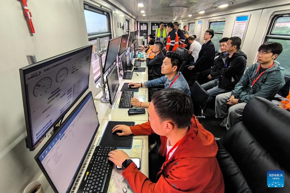 Staff members monitor data during a joint debugging and testing on the high-speed railway connecting Shenyang, capital of northeast China's Liaoning Province, and Changbai Mountain reserve in the neighboring Jilin Province, June 1, 2025. With a length of 430 kilometers and design speed of 350 kilometers per hour, the high-speed railway will significantly improve regional connectivity and boost tourism and economic development upon operation. (China Railway Shenyang Group Co., Ltd/Handout via Xinhua)