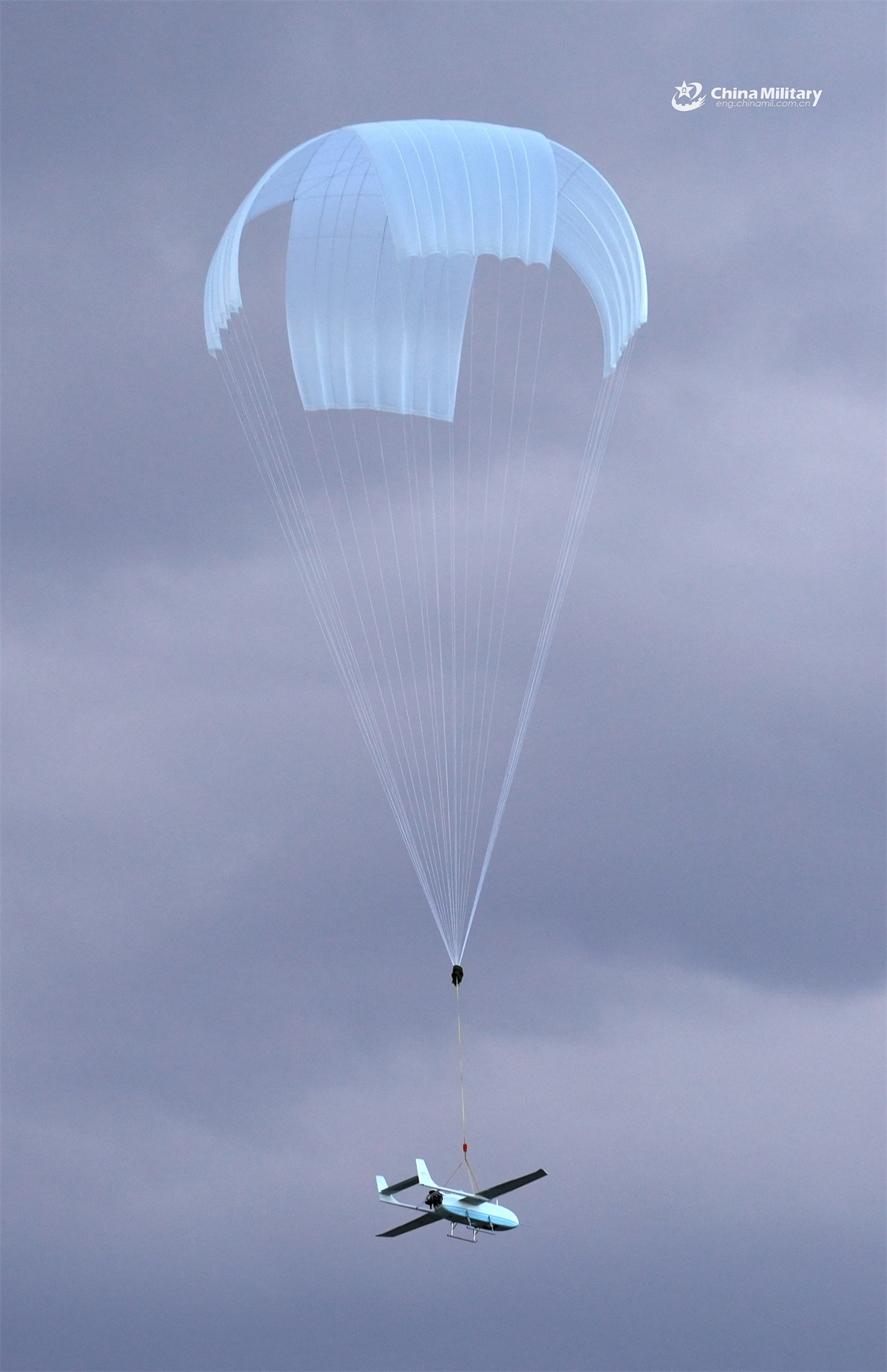 An Unmanned Aerial Vehicle (UAV) attached to a reconnaissance detachment of a brigade under the Chinese PLA 81st Group Army pops a parachute for landing during an UAV reconnaissance training exercise in mid-May, 2025. (eng.chinamil.com.cn/Photo)