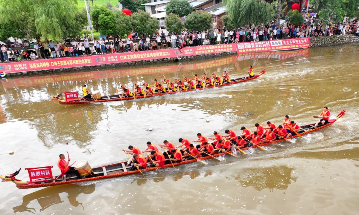 An aerial drone photo taken on May 31, 2025 shows locals compete in a dragon boat race in Qidong County of Hengyang City, central China's Hunan Province. The Dragon Boat Festival, also known as Duanwu Festival, is a traditional Chinese holiday to commemorate ancient Chinese poet Qu Yuan from the Warring States Period (475-221 B.C.). Celebrated on the fifth day of the fifth month of the Chinese lunar calendar, the festival falls on May 31 this year. (Photo by Cao Zhengping/Xinhua)