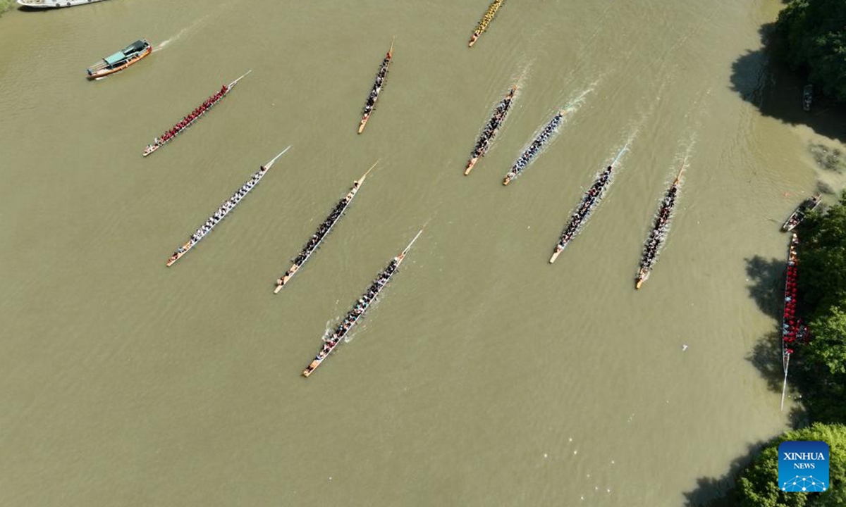 An aerial drone photo taken on May 31, 2025 shows teams competing in a dragon boat race on the Dazhang River in Minhou County, southeast China's Fujian Province. (Xinhua/Jiang Kehong)