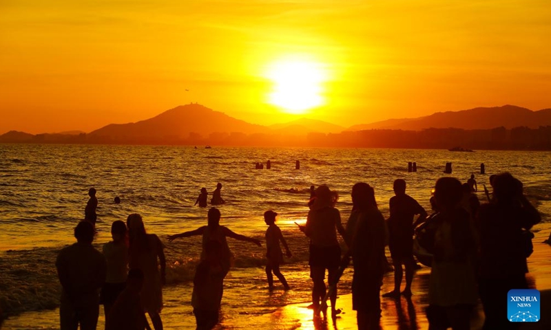 Tourists enjoy leisure time at Sanya Bay in Sanya, south China's Hainan Province, June 2, 2025.