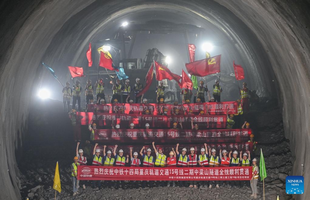 Workers celebrate the full breakthrough of the Zhongliangshan tunnel, a key project along Chongqing Rail Transit Line 15, in southwest China's Chongqing Municipality, June 3, 2025. The 4,944-meter Zhongliangshan tunnel, the longest tunnel bored using the mining method in the second phase of Chongqing Rail Transit Line 15, achieved full breakthrough on Tuesday, marking a major progress in the construction of the city's first urban rail express line. (Xinhua/Chen Cheng)