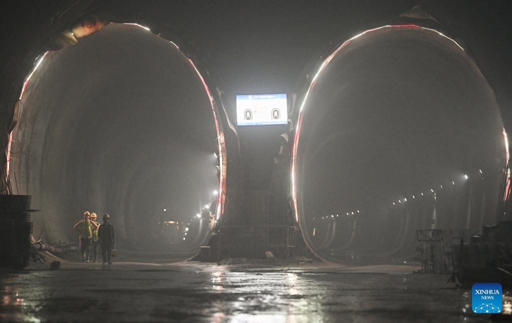 Workers are seen in the Zhongliangshan tunnel, a key project along Chongqing Rail Transit Line 15, in southwest China's Chongqing Municipality, June 3, 2025. The 4,944-meter Zhongliangshan tunnel, the longest tunnel bored using the mining method in the second phase of Chongqing Rail Transit Line 15, achieved full breakthrough on Tuesday, marking a major progress in the construction of the city's first urban rail express line. (Xinhua/Chen Cheng)