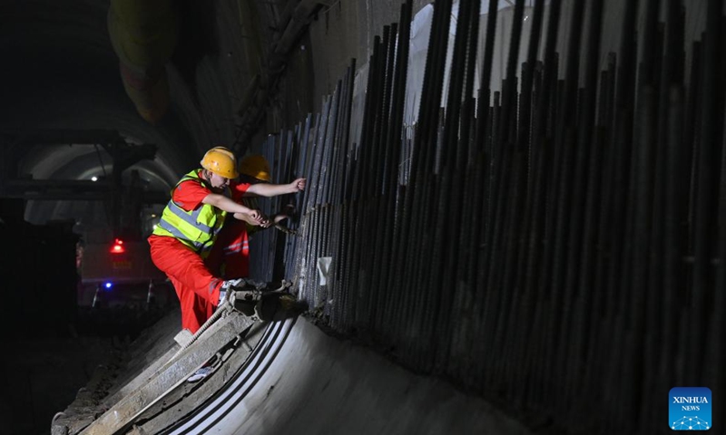 A worker performs his task in the Zhongliangshan tunnel, a key project along Chongqing Rail Transit Line 15, in southwest China's Chongqing Municipality, June 3, 2025. The 4,944-meter Zhongliangshan tunnel, the longest tunnel bored using the mining method in the second phase of Chongqing Rail Transit Line 15, achieved full breakthrough on Tuesday, marking a major progress in the construction of the city's first urban rail express line. (Xinhua/Chen Cheng)