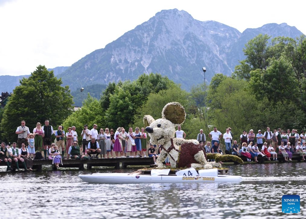 People attend a float parade on water during the Daffodil Festival in Altaussee, Austria, on June 1, 2025. (Xinhua/He Canling)