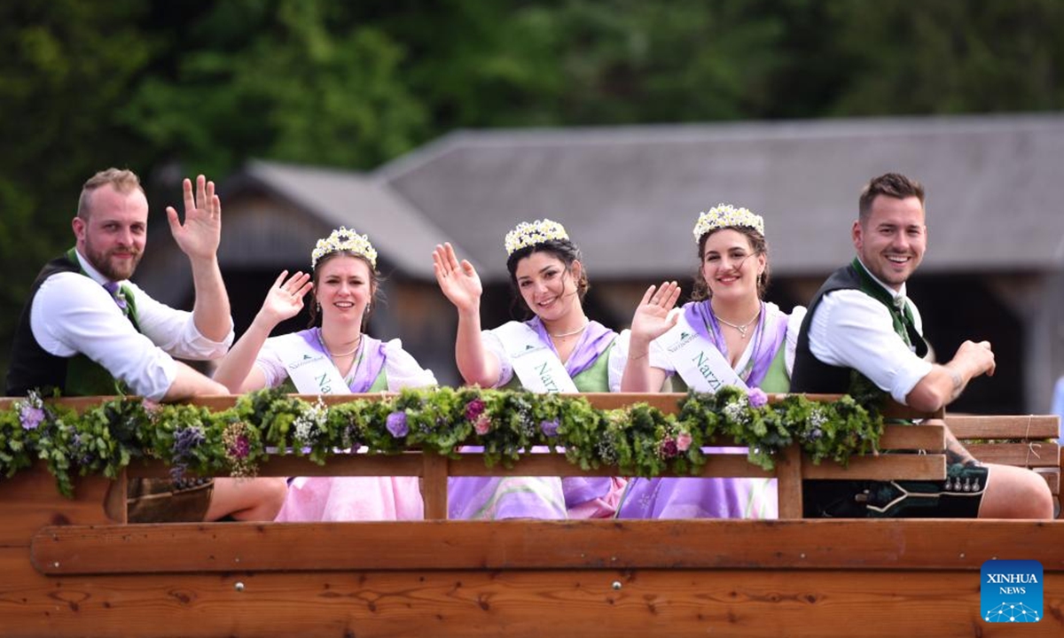 People attend a float parade on water during the Daffodil Festival in Altaussee, Austria, on June 1, 2025. (Xinhua/He Canling)