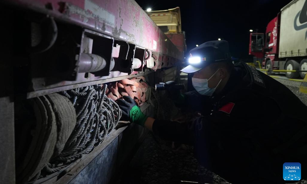 An immigration officer conducts inspection work at Irkeshtam port in Wuqia County, Kirgiz Autonomous Prefecture of Kizilsu in northwest China's Xinjiang Uygur Autonomous Region, June 2, 2025. The Irkeshtam port in northwest China's Xinjiang Uygur Autonomous Region launched a trial of 24-hour freight clearance operations on Sunday, making it the second land port in the region and the first in southern Xinjiang to adopt such a system. This move is aimed at enhancing trade logistics between China and Central Asia, according to the local immigration inspection station. (Photo by Fei Qiang/Xinhua)