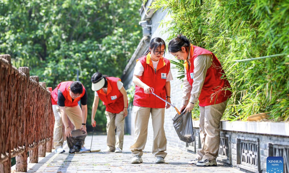 Volunteers collect wastes by a river in Yangzhou, east China's Jiangsu Province, on June 4, 2025. Various events are held to raise people's awareness of environmental protection in China ahead of World Environment Day, which falls on June 5. (Photo by Ren Fei/Xinhua)