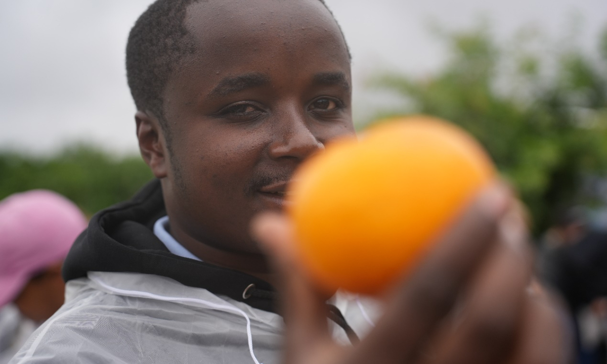 Kenyan agri-entrepreneur Caleb prepares to taste Orri tangors grown at the Binchuan Citrus Science and Technology Backyard demonstration garden. Photo: Wang Lei