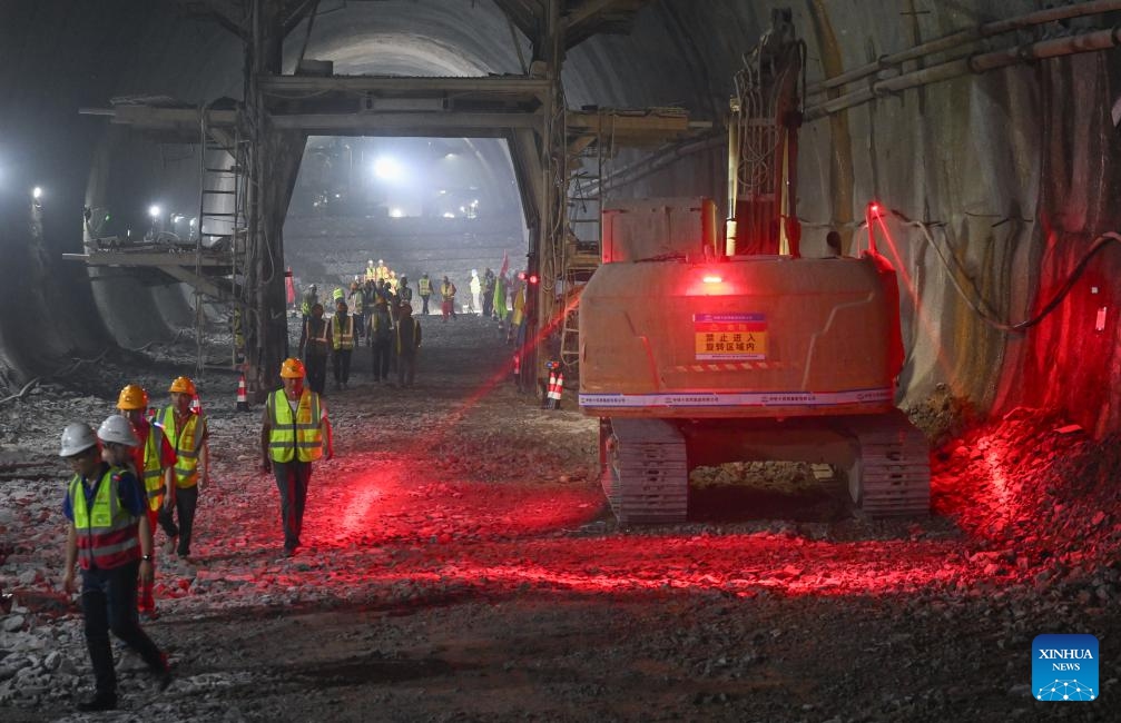 Workers perform their tasks in the Zhongliangshan tunnel, a key project along Chongqing Rail Transit Line 15, in southwest China's Chongqing Municipality, June 3, 2025. The 4,944-meter Zhongliangshan tunnel, the longest tunnel bored using the mining method in the second phase of Chongqing Rail Transit Line 15, achieved full breakthrough on Tuesday, marking a major progress in the construction of the city's first urban rail express line. (Xinhua/Chen Cheng)