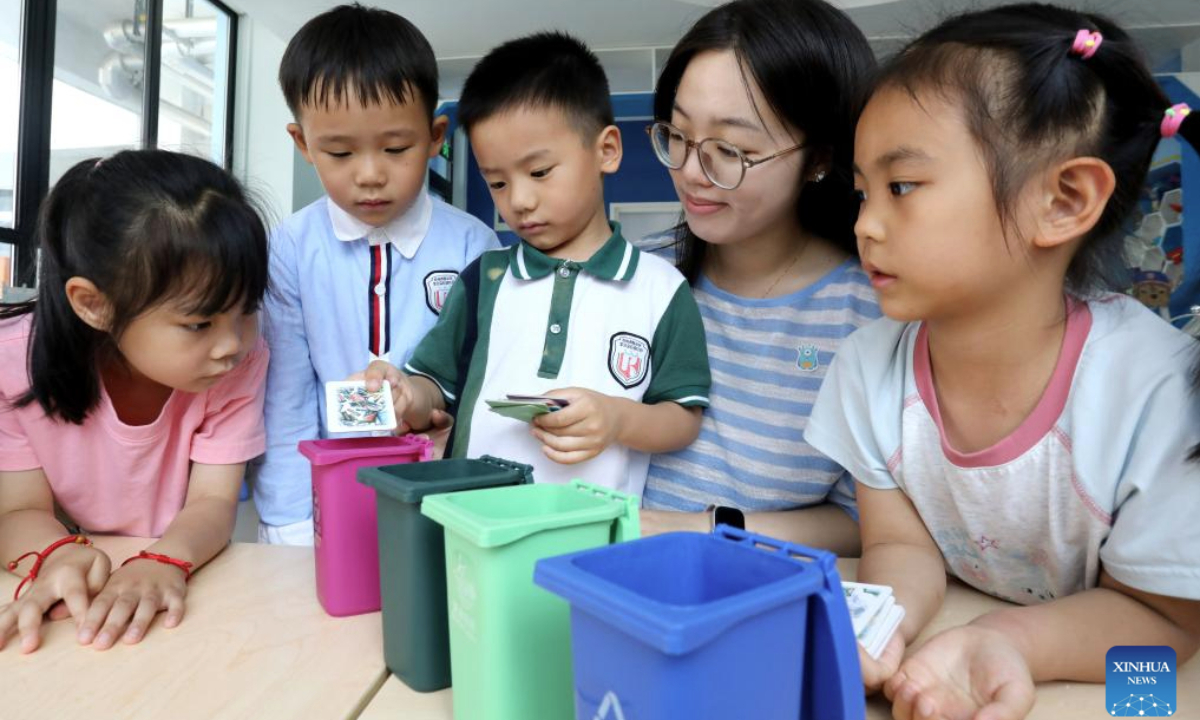 Children take part in a waste-sorting simulation at a kindergarten in Suzhou, east China's Jiangsu Province, on June 3, 2025. Various events are held to raise people's awareness of environmental protection in China ahead of World Environment Day, which falls on June 5. (Photo by Hang Xingwei/Xinhua)