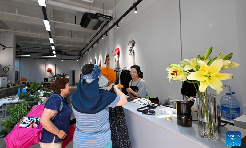 Citizens shop in a commercial block transformed from old factories in Tianjin Tractor Factory area, north China's Tianjin, May 30, 2025. (Xinhua/Sun Fanyue)