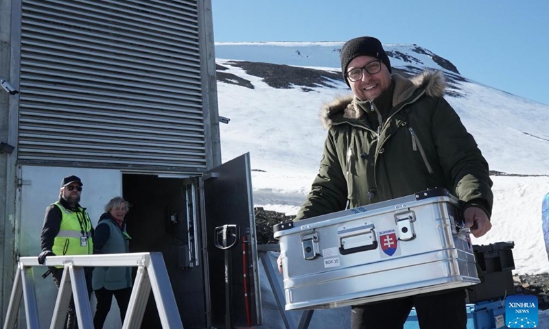 Staff members transport seed samples into the Svalbard Global Seed Vault in Longyearbyen, Svalbard, Norway, on June 3, 2025. Fourteen gene banks from around the world are depositing more than 11,200 seed samples this week at the Svalbard Global Seed Vault, underscoring the critical role of crop diversity in future food security. (Crop Trust/Handout via Xinhua)