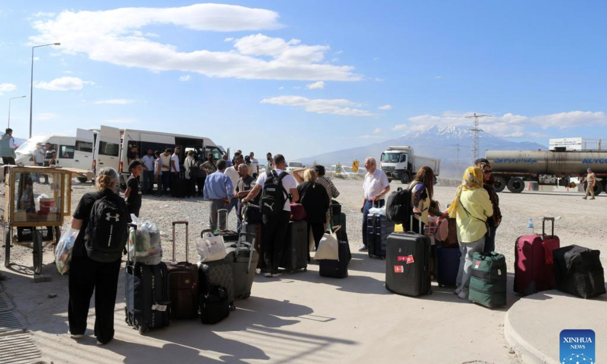 Iranians are seen at the Gurbulak border gate in Agri, Türkiye, on June 18, 2025. Türkiye has increased security measures along its borders amid rising tensions in the region following recent hostilities between Iran and Israel, Defence Minister Yasar Guler said on Wednesday. (Mustafa Kaya/Handout via Xinhua)