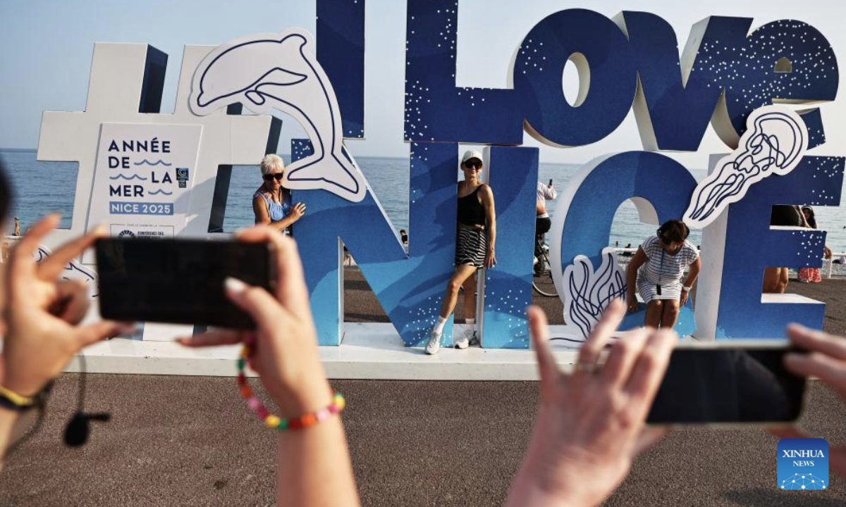 People take photos with an installation marking the third United Nations Ocean Conference (UNOC3) on the Promenade des Anglais in Nice, France, June 10, 2025. The UNOC3 opened on Monday in Nice, a coastal city in southern France, under the theme of Accelerating action and mobilizing all actors to conserve and sustainably use the ocean. (Xinhua/Gao Jing)