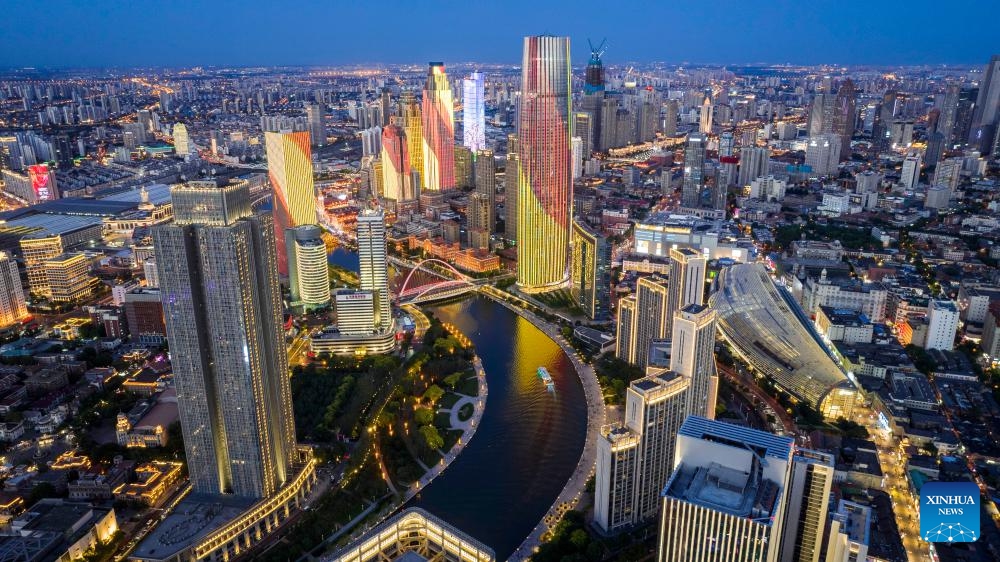 An aerial drone photo taken on June 4, 2025 shows a night view along the Haihe River in north China's Tianjin. Tianjin has upgraded the lighting facilities of 216 buildings, 13 bridges, 8.2 kilometers of riverbanks and 7 docks along the Haihe River since the beginning of this year. The landscape lighting along the river has been greatly improved, outlining a distinctive night view of the city. (Photo: Xinhua)