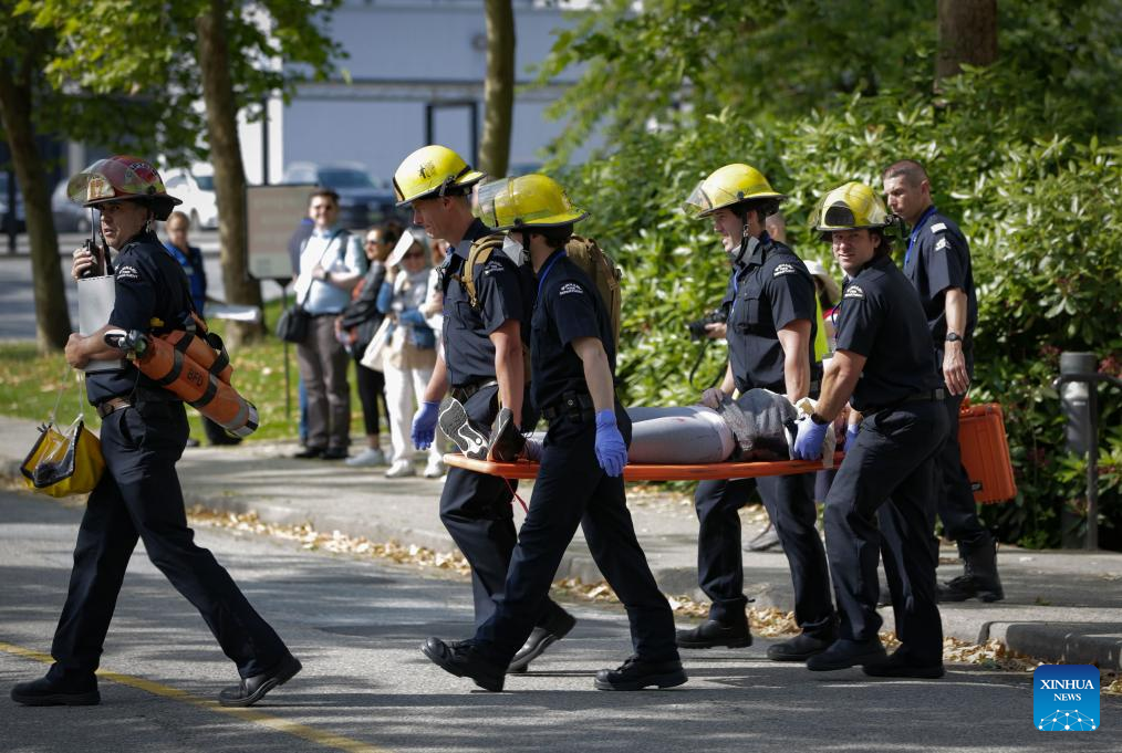 Firefighters carry a victim during an emergency response exercise in Burnaby, British Columbia, Canada, on June 11, 2025. As one of the city's largest emergency response exercises, the event involved simulated earthquake-related injuries and hazards for participants to enhance response skills and strengthen coordination. (Photo by Liang Sen/Xinhua)