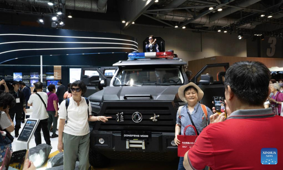 People pose for photos at the 2025 International Automotive & Supply Chain Expo (Hong Kong) in Hong Kong, south China, June 12, 2025. The 2025 International Automotive & Supply Chain Expo (Hong Kong) opened here on Thursday. (Xinhua/Lui Siu Wai)