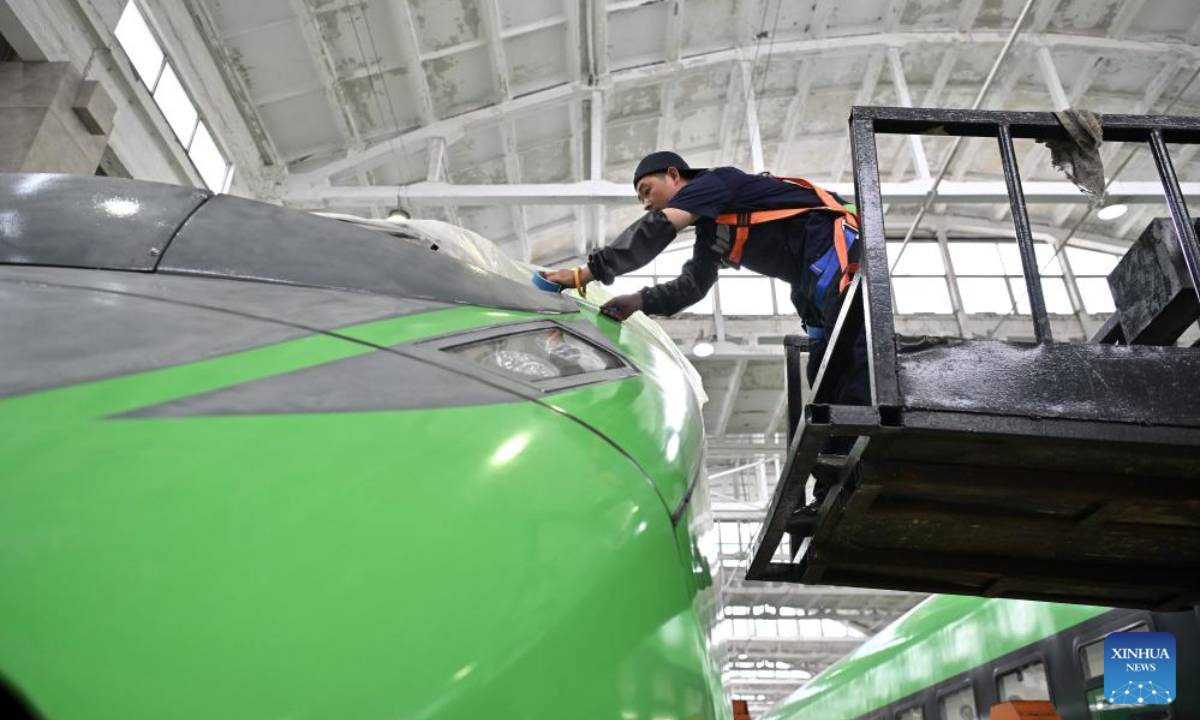 A staff member examines and maintains a train at a depot of China Railway Taiyuan Group Co., Ltd. in Taiyuan, north China's Shanxi Province, June 17, 2025. Staff memebers of China Railway Taiyuan Group Co., Ltd. has stepped up maintenance of trains to ensure safe travel for the upcoming summer travel rush. (Xinhua/Zhan Yan)