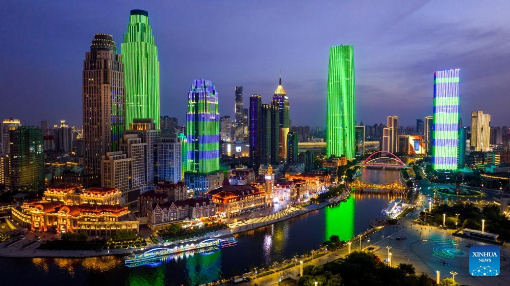 An aerial drone photo taken on June 5, 2025 shows a night view along the Haihe River in north China's Tianjin. Tianjin has upgraded the lighting facilities of 216 buildings, 13 bridges, 8.2 kilometers of riverbanks and 7 docks along the Haihe River since the beginning of this year. The landscape lighting along the river has been greatly improved, outlining a distinctive night view of the city. (Photo: Xinhua)