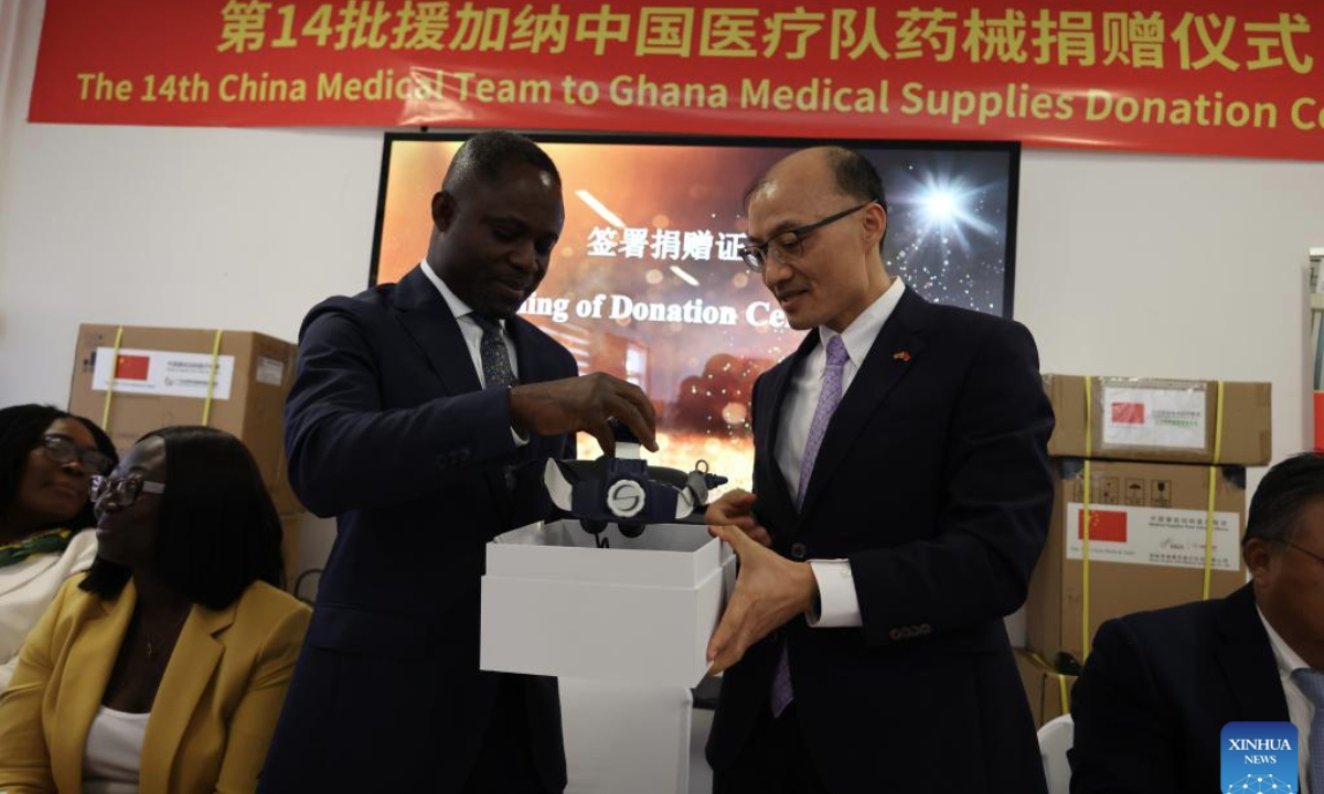 Chinese Ambassador to Ghana Tong Defa (C-R) hands over a medical device to Ghana's Health Minister Kwabena Mintah Akandoh (C-L) during a donation ceremony at Lekma Hospital in Accra, Ghana, on June 16, 2025. (Photo by Seth/Xinhua)