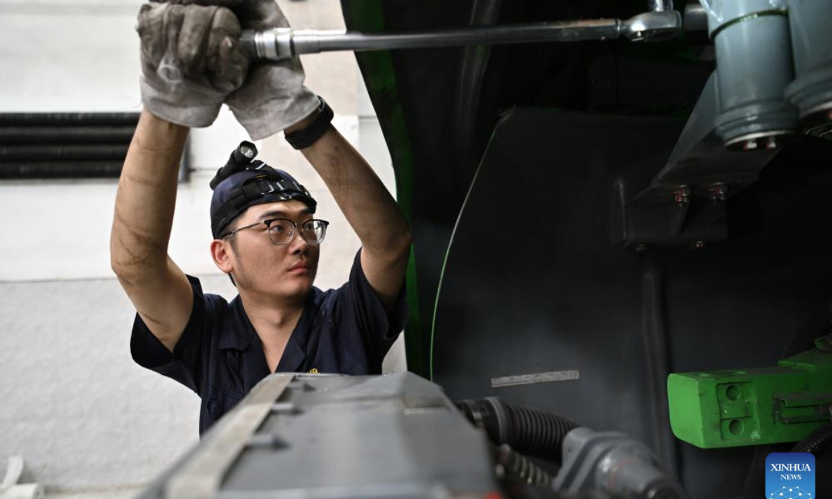 A staff member examines and maintains a train at a depot of China Railway Taiyuan Group Co., Ltd. in Taiyuan, north China's Shanxi Province, June 17, 2025. Staff memebers of China Railway Taiyuan Group Co., Ltd. has stepped up maintenance of trains to ensure safe travel for the upcoming summer travel rush. (Xinhua/Zhan Yan)