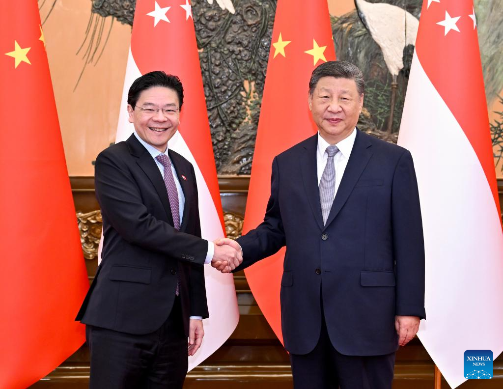 Chinese President Xi Jinping meets with Singaporean Prime Minister Lawrence Wong, who is on an official visit to China, at the Great Hall of the People in Beijing, capital of China, June 24, 2025. (Xinhua/Yue Yuewei)