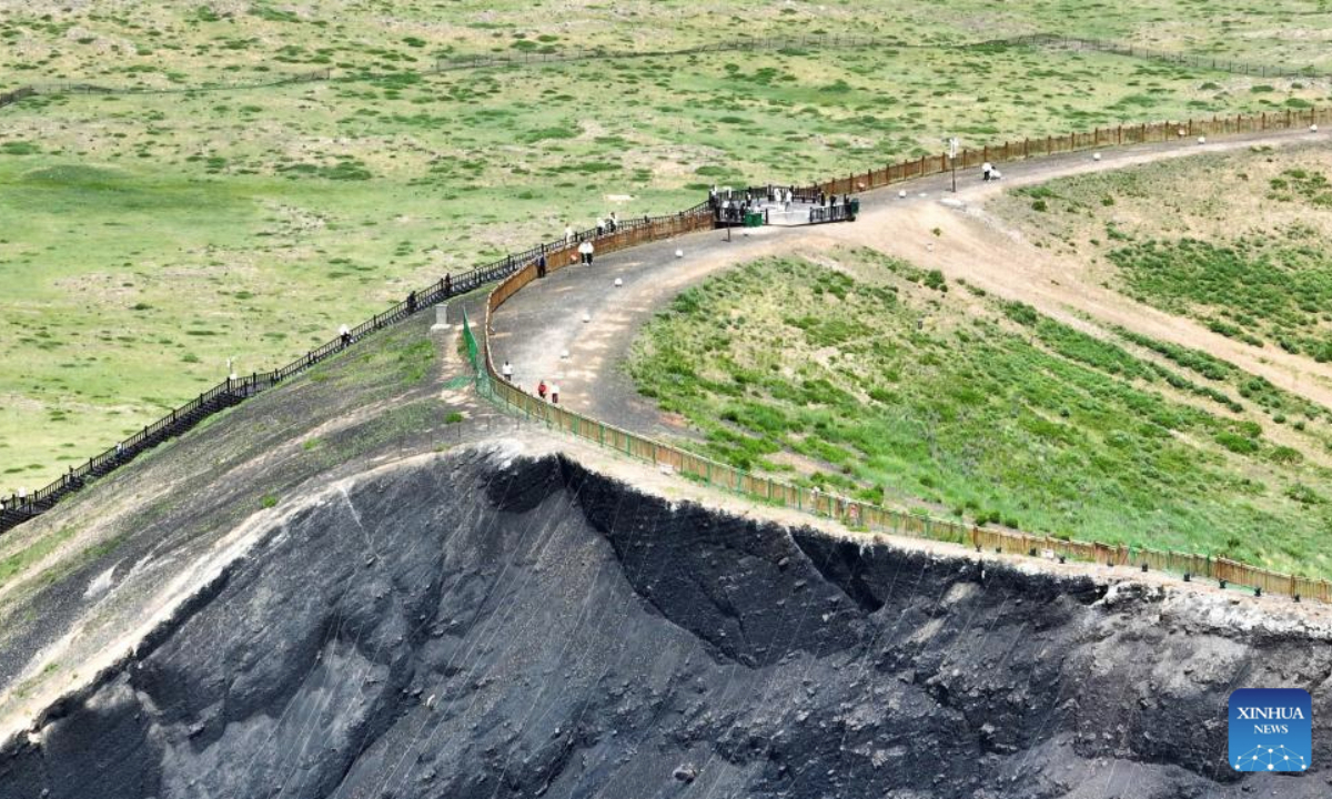 An aerial drone photo taken on June 17, 2025 shows tourists visiting the Ulanhada volcano cluster in Qahar Right Wing Rear Banner of Ulanqab, north China's Inner Mongolia Autonomous Region. The Ulanhada volcano cluster boasts special geological landscapes such as volcanoes and lava landform. With summer's arrival, it has entered the peak tourist season. (Xinhua/Ma Jinrui)