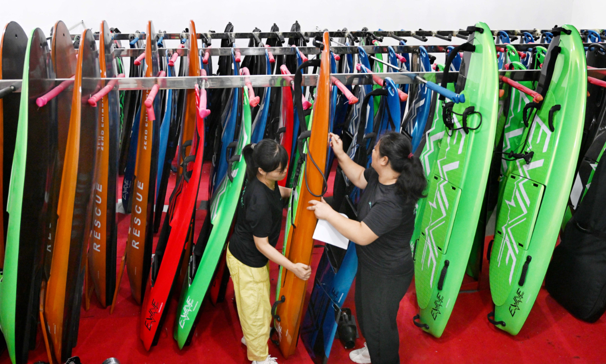 Workers assemble electric surfboards for overseas markets at a workshop in Wuyi county, Jinhua, in East China’s Zhejiang Province on June 23, 2025. With the arrival of summer, the company’s water sports products are in high demand and are exported to countries and regions including Dubai, Russia, Australia, Italy, Kazakhstan, and Indonesia. Photo: VCG
