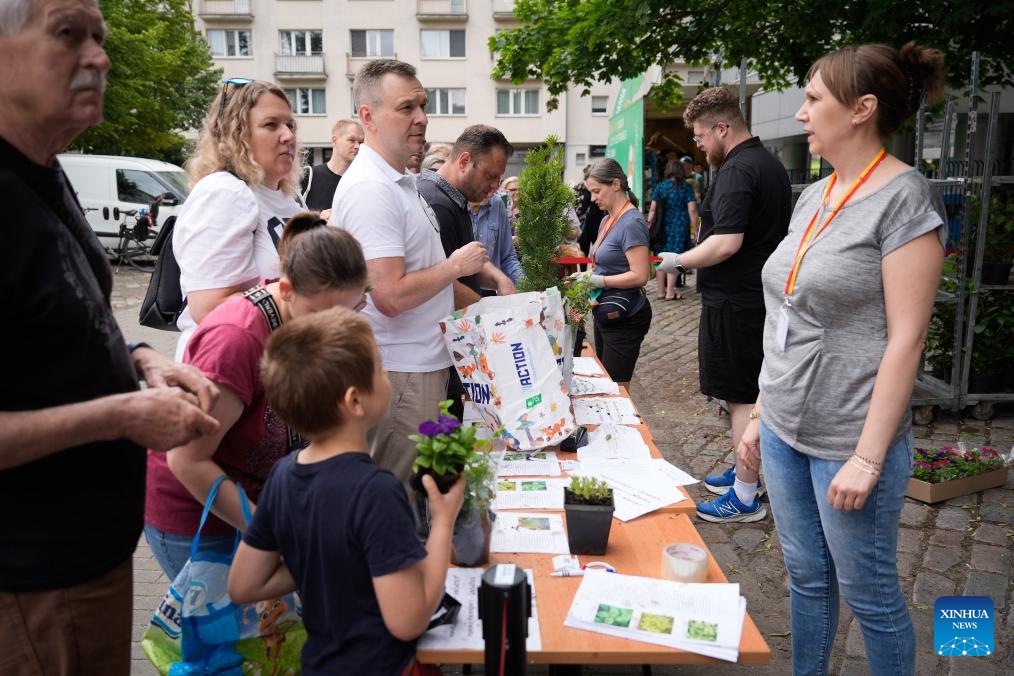People exchange discarded electrical appliances for plants in Warsaw, Poland, on June 7, 2025. Warsaw has organized multiple swap points where people can bring discarded electrical appliances in exchange for plants. (Photo: Xinhua)