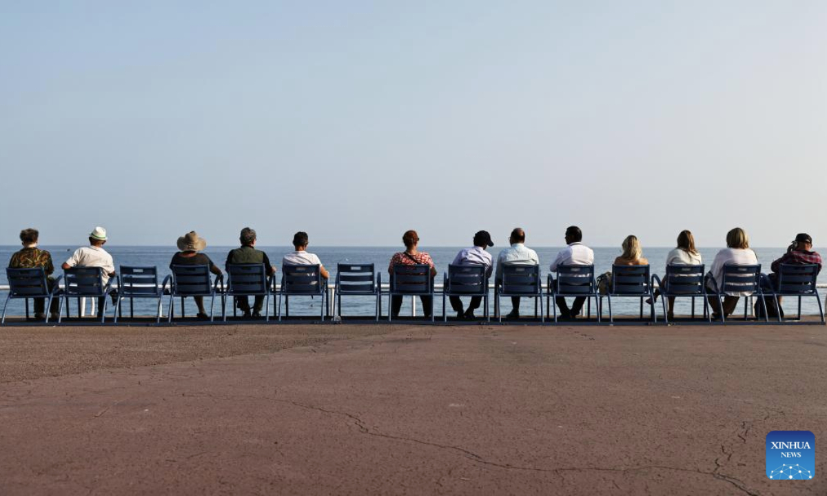 People sitting in the well noted blue chairs enjoy the sea view in Nice, France, June 10, 2025. The UNOC3 opened on Monday in Nice, a coastal city in southern France, under the theme of Accelerating action and mobilizing all actors to conserve and sustainably use the ocean. (Xinhua/Gao Jing)