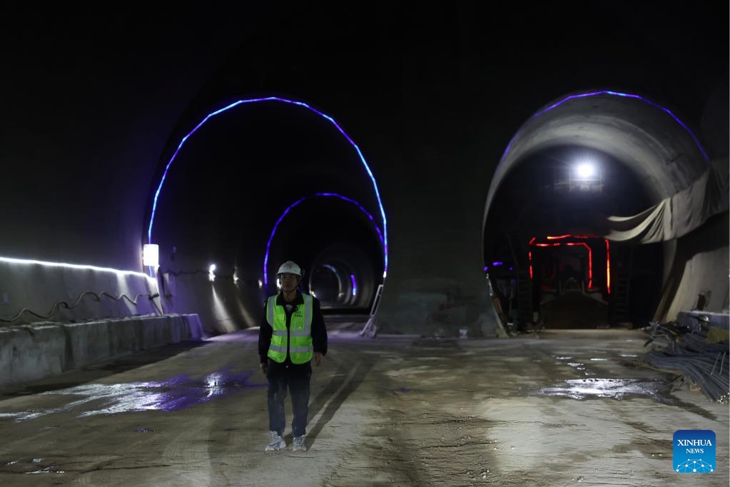 A constructor walks at the construction site of Zhaowan Tunnel of Lanzhou-Hezuo high-speed railway in Linxia Hui Autonomous Prefecture, northwest China's Gansu Province, June 6, 2025. The Zhaowan Tunnel, with a total length of 1642.35 meters and a relative height difference of 370 meters, was drilled through on Friday. The tunnel is a key project of Lanzhou-Hezuo high-speed railway, a part of China's high-speed rail network that centers around eight main vertical lines linking the north and south and eight horizontal lines connecting the east and west. (Photo: Xinhua)