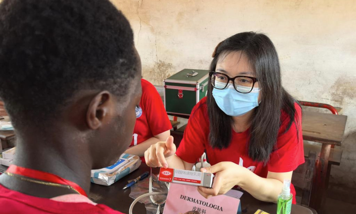 Chinese doctor He Yongjie offers consultation to a local student on his skin problem at the Samora Moises Machel High School in Bissau, capital of Guinea-Bissau, June 13, 2025.(The 20th batch of Chinese medical team in Guinea-Bissau/Handout via Xinhua)