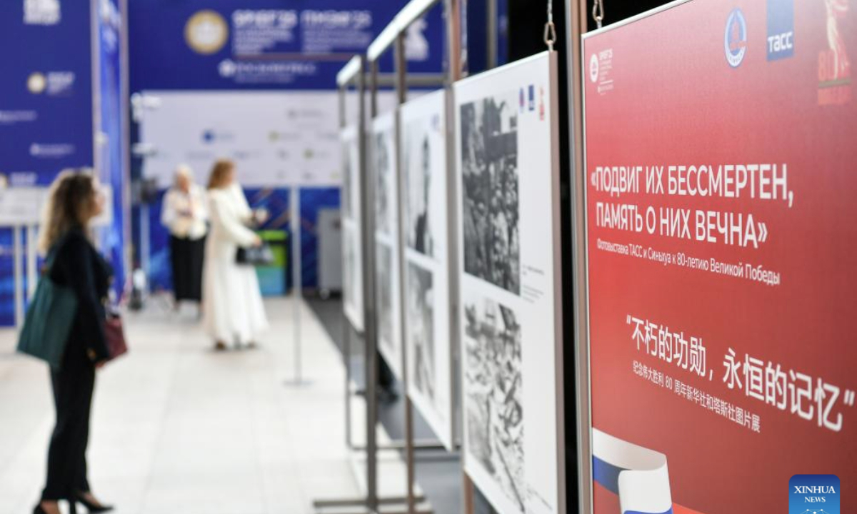 People visit a photo exhibition marking the 80th anniversary of the victory of the World Anti-Fascist War in St. Petersburg, Russia, June 19, 2025. Titled Immortal Merits, Eternal Memory, the exhibition was co-hosted by Xinhua News Agency and TASS news agency. (Xinhua/Cao Yang)