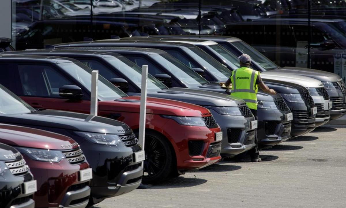 A worker cleans Land Rover cars at a Jaguar Land Rover dealership in Reading Britain on June 24, 2020. (Photo by Tim Ireland/Xinhua)
