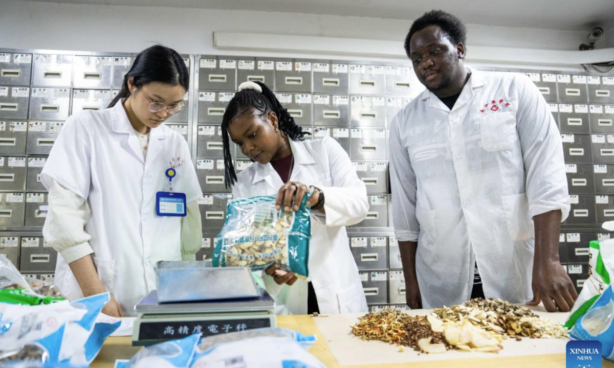 International student Ekpene Mabel Solomon (C) from Nigeria collects Chinese medicine at the first affiliated hospital of Changsha Medical University in Changsha, central China's Hunan Province, June 18, 2025.
The international exchanges division of Changsha Medical University was established in 2006. Currently, more than 20 international students from 13 African countries are pursuing further studies at the institution.
The school promotes cultural exchange globally while popularizing traditional Chinese medicine through courses including surgery, medicine, acupuncture, and tuina (therapeutic massage). (Xinhua/Chen Sihan)