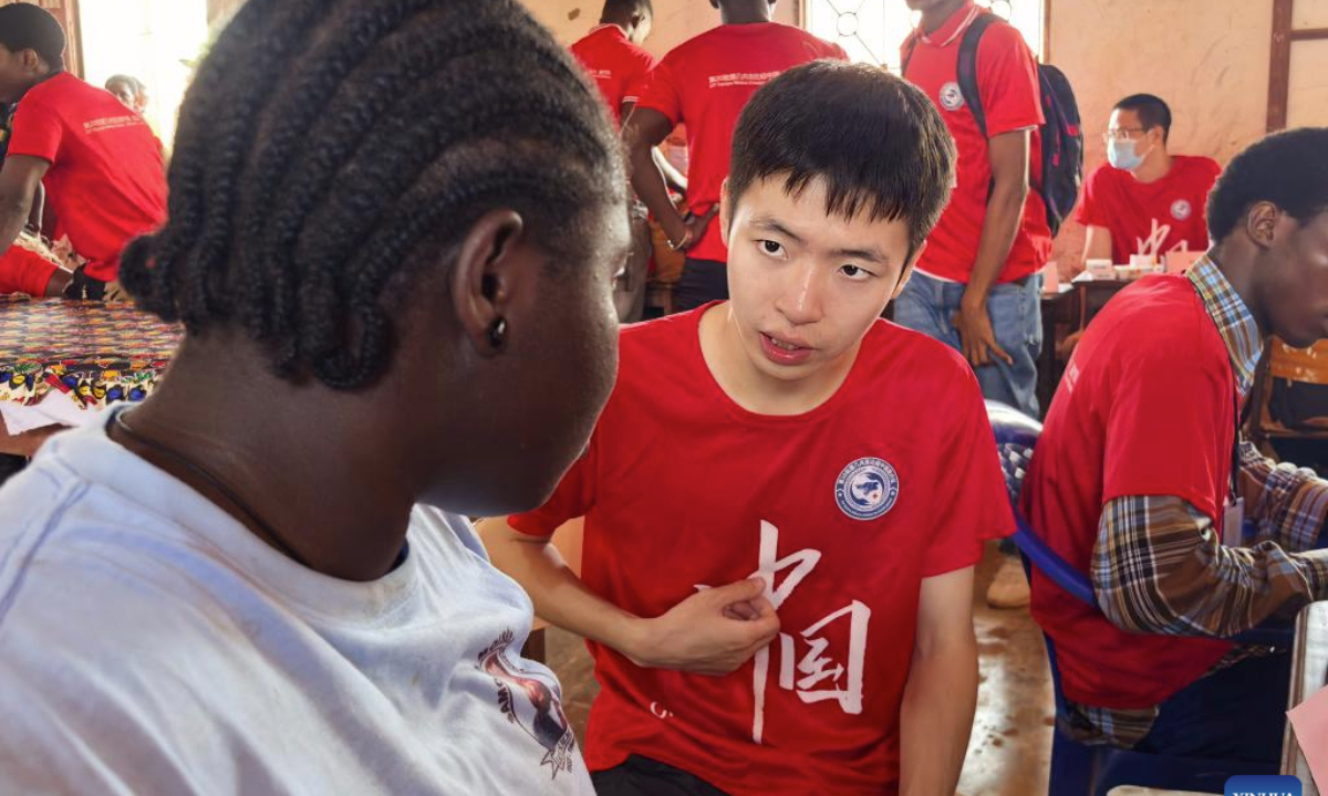 Chinese interpreter Fan Jiawei serves a local student at the Samora Moises Machel High School in Bissau, capital of Guinea-Bissau, June 13, 2025.(The 20th batch of Chinese medical team in Guinea-Bissau/Handout via Xinhua)