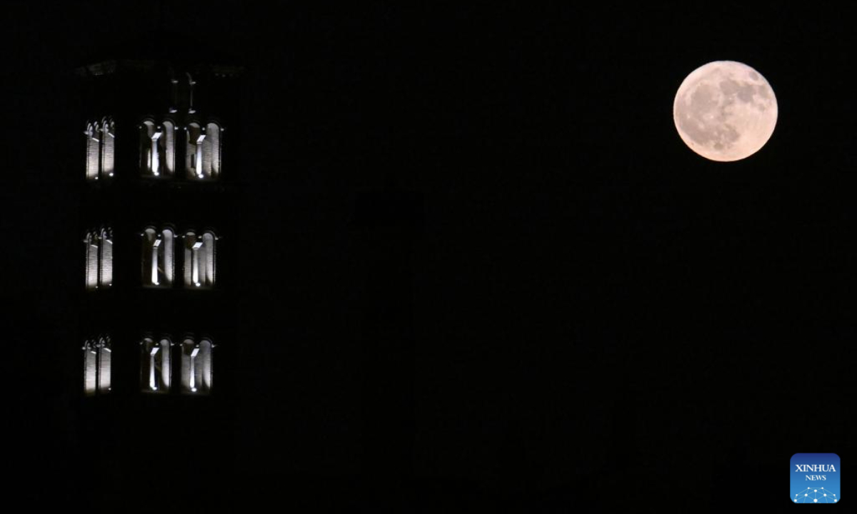 A full moon is pictured with the Imperial Forum in Rome, Italy, on June 11, 2025. (Photo by Alberto Lingria/Xinhua)