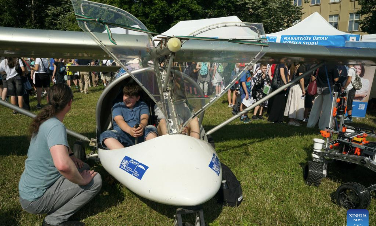 Boys sit in an ultralight aircraft at Science Fest, a fun open-air science festival, in Prague, the Czech Republic, on June 18, 2025. (Photo by Dana Kesnerova/Xinhua)