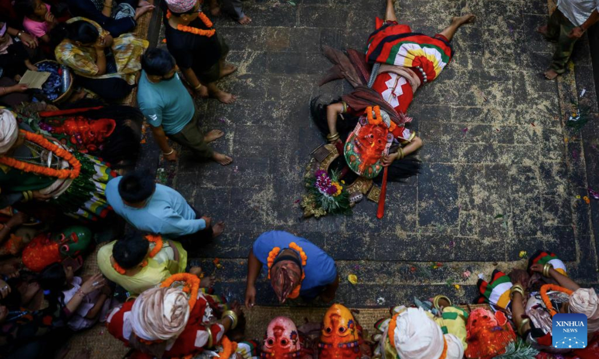 People watch a traditional Navadurga dance performance in Bhaktapur, Nepal, June 18, 2025. Navadurga means nine forms of goddess Durga. (Photo by Sulav Shrestha/Xinhua)