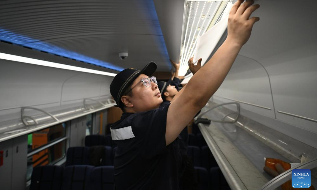 Staff members examine and maintain a train at a depot of China Railway Taiyuan Group Co., Ltd. in Taiyuan, north China's Shanxi Province, June 17, 2025. Staff memebers of China Railway Taiyuan Group Co., Ltd. has stepped up maintenance of trains to ensure safe travel for the upcoming summer travel rush. (Xinhua/Zhan Yan)