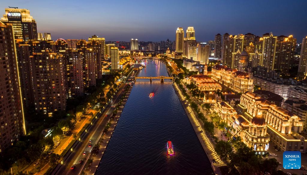 An aerial drone photo taken on June 4, 2025 shows cruise ships sailing on the Haihe River in north China's Tianjin. Tianjin has upgraded the lighting facilities of 216 buildings, 13 bridges, 8.2 kilometers of riverbanks and 7 docks along the Haihe River since the beginning of this year. The landscape lighting along the river has been greatly improved, outlining a distinctive night view of the city. (Photo: Xinhua)