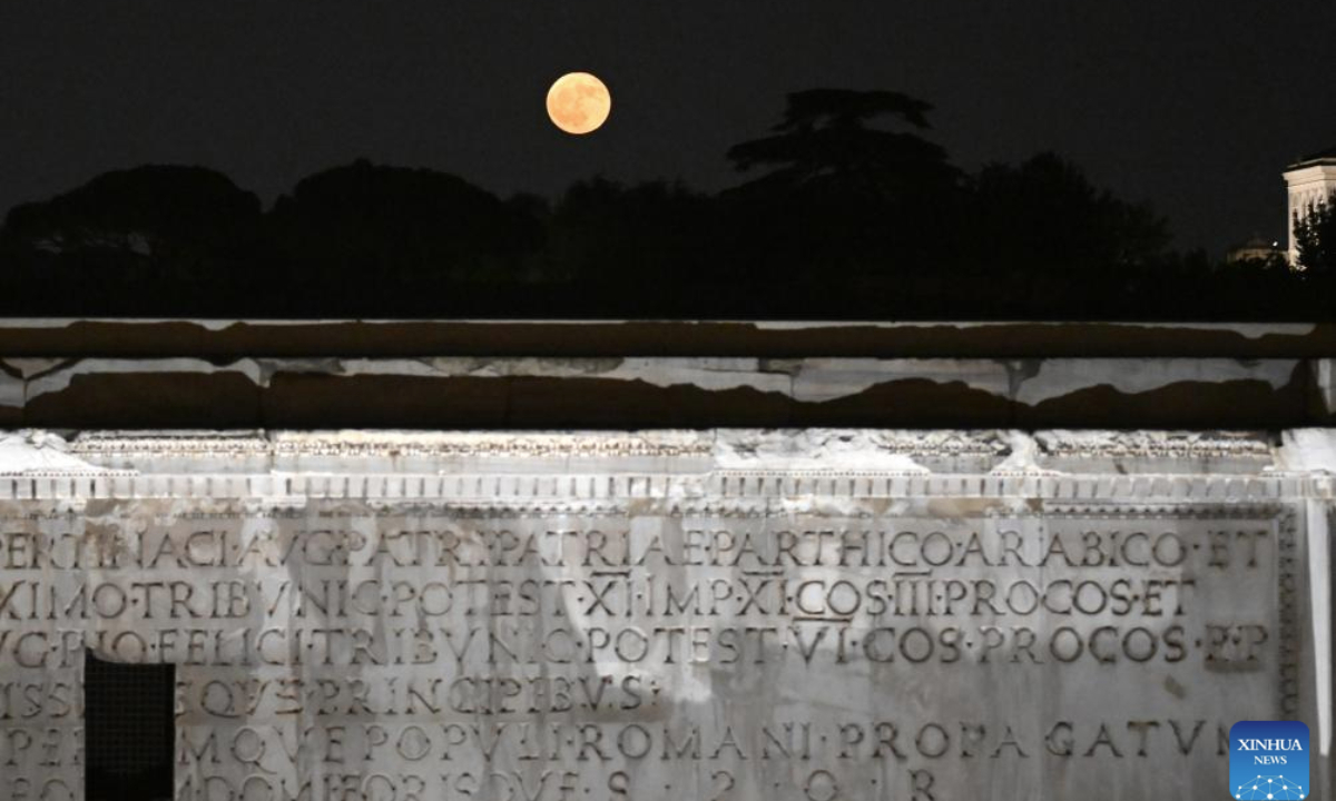 A full moon is pictured with the Imperial Forum in Rome, Italy, on June 11, 2025. (Photo by Alberto Lingria/Xinhua)