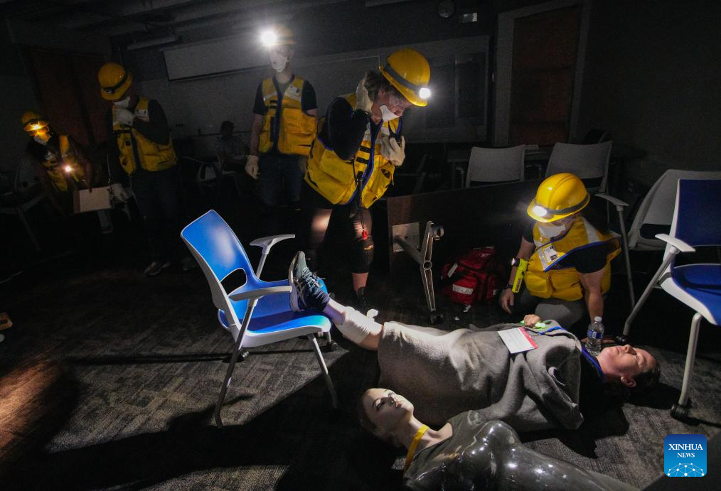 Members of a search and rescue team rescue a victim in a mock earthquake scenario during an emergency response exercise in Burnaby, British Columbia, Canada, on June 11, 2025. As one of the city's largest emergency response exercises, the event involved simulated earthquake-related injuries and hazards for participants to enhance response skills and strengthen coordination. (Photo by Liang Sen/Xinhua)