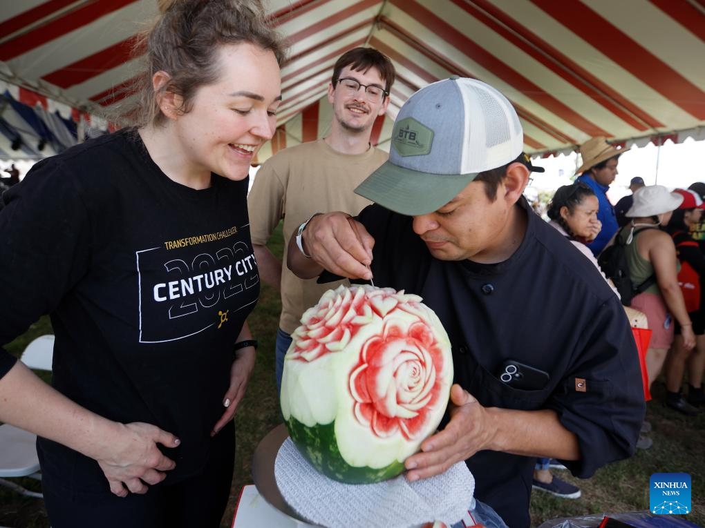 A man carves a watermelon during the 2025 California Watermelon Festival at the Hansen Dam Park in Los Angeles, California, the United States, June 7, 2025. (Photo: Xinhua)