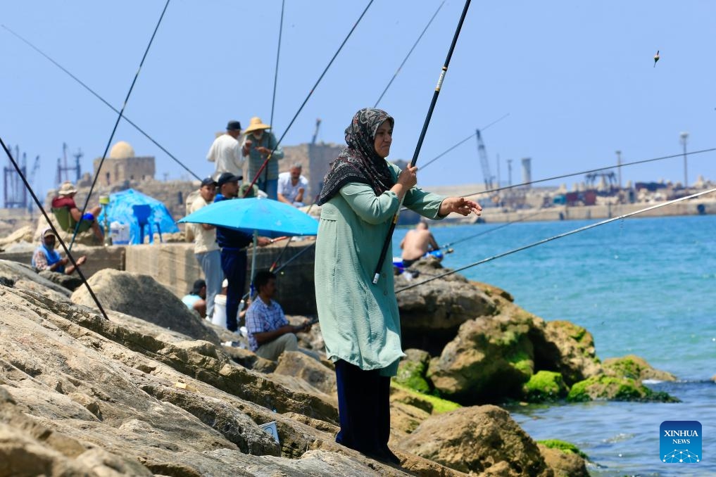 Citizens enjoy fishing during the Eid al-Adha holiday on the beach in Sidon, Lebanon, on June 7, 2025. (Photo: Xinhua)