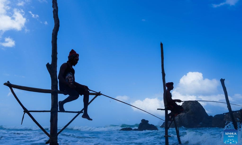 Stilt fishermen are seen near the southern Sri Lankan city of Galle, June 5, 2025. (Photo: Xinhua)
