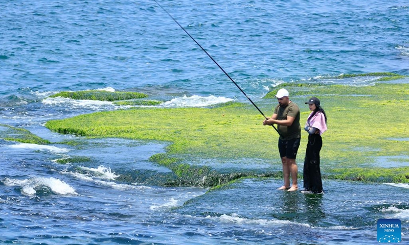 Citizens enjoy fishing during the Eid al-Adha holiday on the beach in Sidon, Lebanon, on June 7, 2025. (Photo: Xinhua)