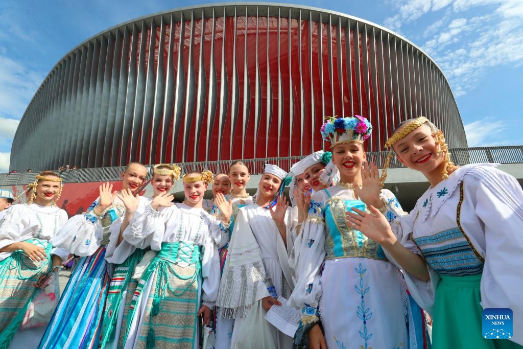 Women dressed in traditional attires pose for a group photo in front of the Belarusian National Football Stadium, a landmark project built with Chinese support, in Minsk, Belarus, June 7, 2025. The Belarusian National Football Stadium officially opened here on Saturday evening, with President Alexander Lukashenko attending the inauguration ceremony. (Photo: Xinhua)