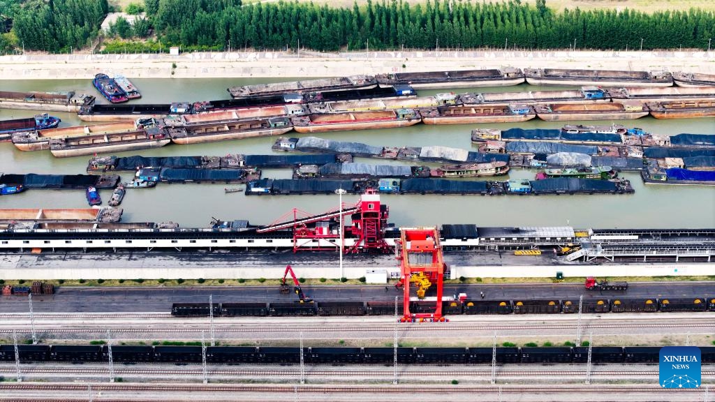 An aerial drone photo taken on June 8, 2025 shows ships docking for coal transportation at Liangshan Port in Jining, east China's Shandong Province. Liangshan Port serves as an important logistics hub connecting the western coal-producing areas with the Yangtze River Economic Belt. To ensure the coal supply during the peak demand period in summer, Liangshan Port has focused on streamlining the mining, storage, transportation and sales of coal. The port has put a transfer project into operation, which connects railway transportation with waterway transportation. (Photo: Xinhua)